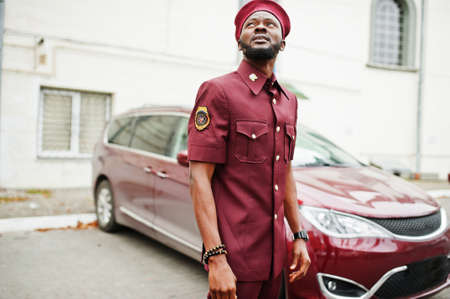 Portrait of African American military man in red uniform and beret near car.の写真素材