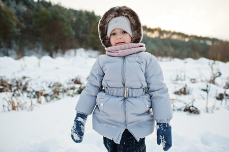 Baby girl in winter nature. Outdoors in snow.の写真素材