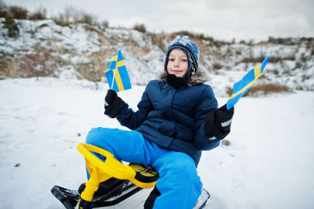 Scandinavian boy with Sweden flag in winter swedish landscape.の写真素材