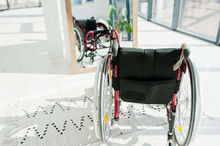 Empty wheelchair at home. Wheel chair indoor in mirror.の写真素材