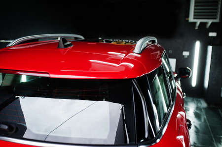 Red polished car in professional detailing garage.の写真素材