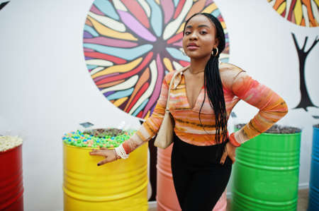 African american millennial lady at candy shop.