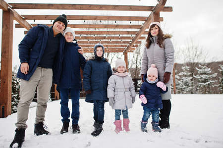 Big young family with four kids in winter day.