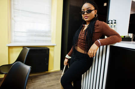 African american model wearing sunglasses in cafe.