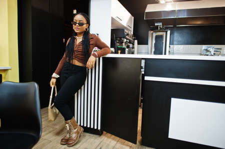 African american model wearing sunglasses in cafe.の写真素材