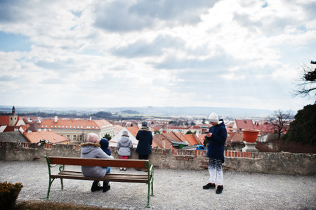 Family walking at historical Mikulov Castle, Moravia, Czech Republic. Old European town.