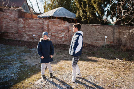 Two brothers walking at sunny spring day.の写真素材