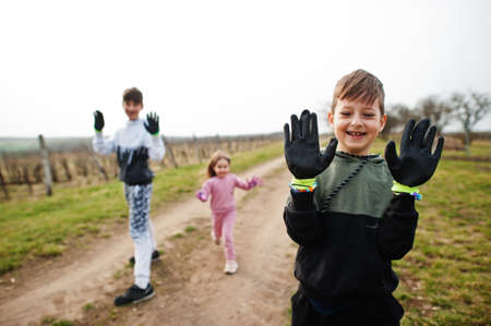 Children cleaning in the vineyards, show their gloves . Environmental conservation and ecology, recycling.の写真素材