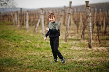 Smiling boy play in vineyard at spring.の写真素材