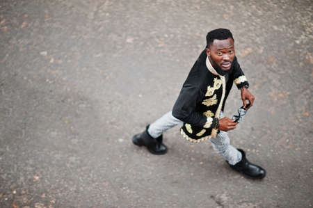 Mega stylish african man in traditional jacket pose. Fashionable black guy in sunglasses.の写真素材