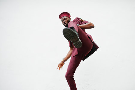Kick by leg. Portrait of African American military man in red uniform and beret.の写真素材