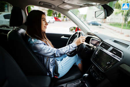 Gorgeous woman sitting inside car interior.の写真素材
