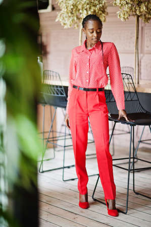 Pretty braids business african american lady bright bossy person friendly wear office red shirt and trousers.の写真素材