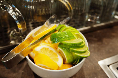 Lemon and lime slices in bowl for cocktails.の写真素材
