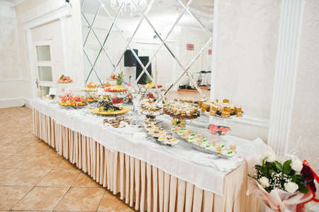 Beautiful wedding candy bar with sweets, fruits and food. Wedding banquet tableの写真素材