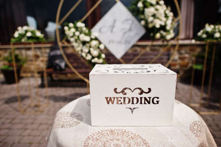 Wooden wedding box for money in table.の写真素材