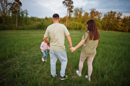 Couple with kids together at meadow.の写真素材