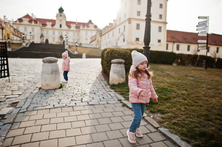Two girls, wear pink jacket walking at Valtice town, Czech Republic.の写真素材