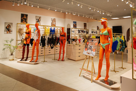 Lviv, Ukraine - October 09, 2022: Orange female mannequins in underwear. Lingerie store, lace bra and panties in a shop.のeditorial素材