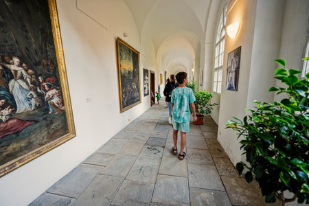 Rajhrad, Czech Republic - May 22, 2022: Boy walking in exhibition art gallery at Benedictine...