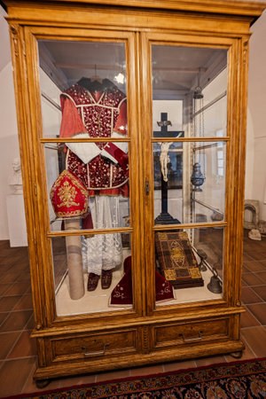 Rajhrad, Czech Republic - May 22, 2022: Priestly clothes and cross in the closet at museum of monastery in Rajhrad
, Czech Republic.のeditorial素材