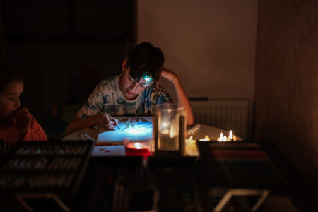 Family spending time together during an energy crisis in Europe causing blackouts. Kids drawing in...