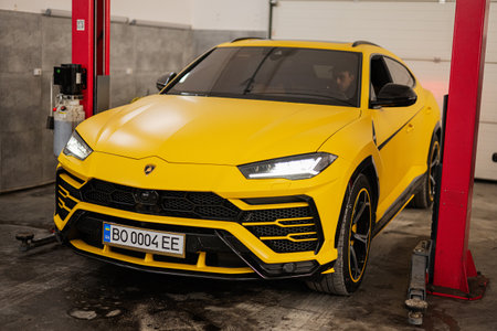 Ternopil, Ukraine- November 11, 2022:  Yellow Lamborghini Urus in car service station.のeditorial素材