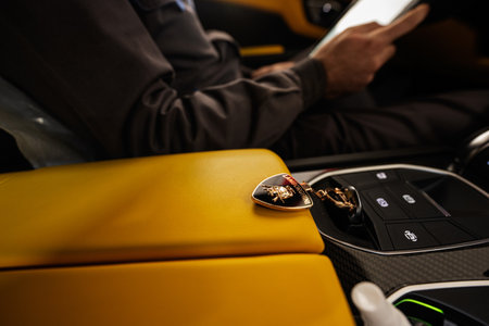 Ternopil, Ukraine- November 11, 2022:  Keys inside yellow Lamborghini Urus with driver.のeditorial素材