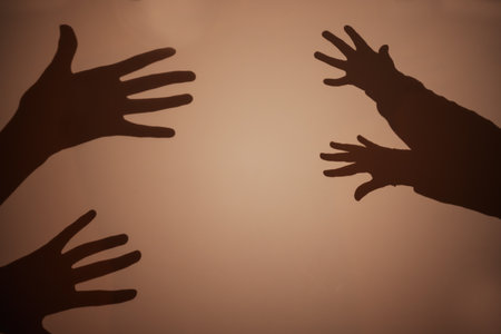 Shadow of the hand and fingers on the wall.の写真素材