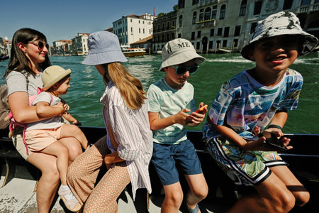 Large family in gondola , many kids with mother in Venice, Italy.の写真素材