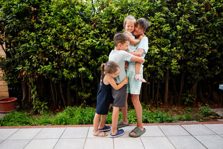 Four happy kids on the terrace of the house. Brothers and sisters.の写真素材