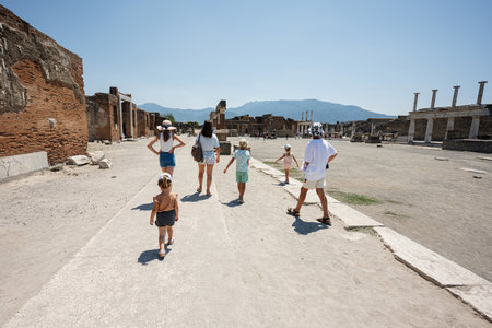 Back of family tourist walking at Pompeii ancient city, Italy.の写真素材