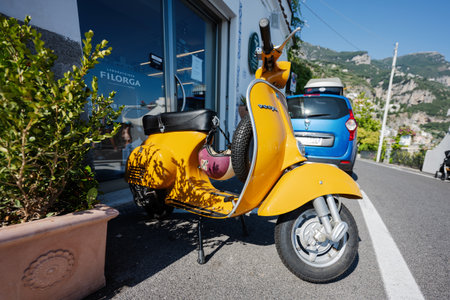 Positano, Italy - July 20, 2022: 1964 vintage yellow Vespa scooter on road of Positano, Italy.のeditorial素材