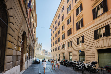 Family tourists walk in Via Daniele Manin street, Rome, Italy.の写真素材