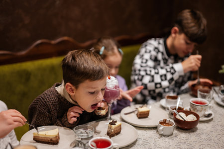 Happy family eating desserts together at cozy cafe and having fun.
