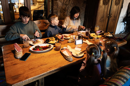Family having a meal together in authentic ukrainian restaurant.