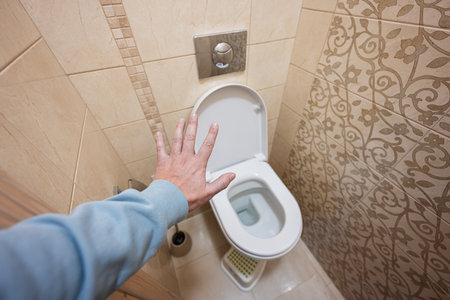 Man show stop hand in the toilet room.の写真素材