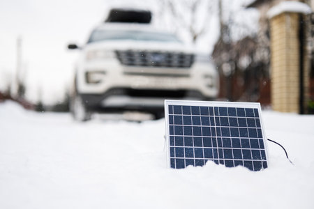 Portable solar panel against SUV car at winter.の写真素材
