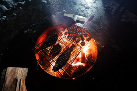 Grilled fresh seafood with fish at night barbecue.