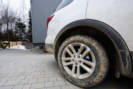 Close up mud dirty wheel of off road SUV car. Adventure in mountains.