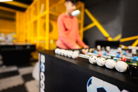 Playing table football in kids play center.の写真素材