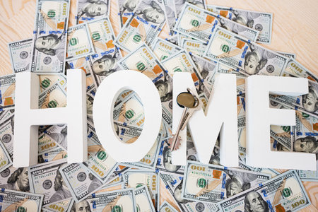Home letters against dollar money with keys background.の写真素材