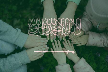 Hands of kids on background of Saudi Arabia flag. Saudi Arabian patriotism and unity concept.の写真素材