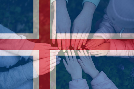 Hands of kids on background of Iceland flag. Icelander patriotism and unity concept.の写真素材