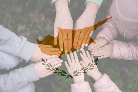 Hands of kids on background of Cyprus flag. Cypriot patriotism and unity concept.の写真素材