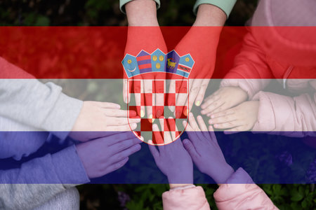 Hands of kids on background of Croatia flag. Croatian patriotism and unity concept.の写真素材