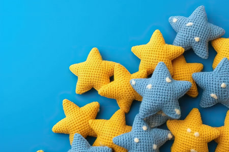 Knitted toy yellow children stars on blue background, flat lay. Generative AI.の素材
