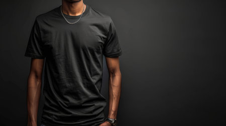 Stylish black men's t-shirt displayed on a mannequin, isolated on a dark background. Perfect for showcasing men's fashion and casual wear.の素材