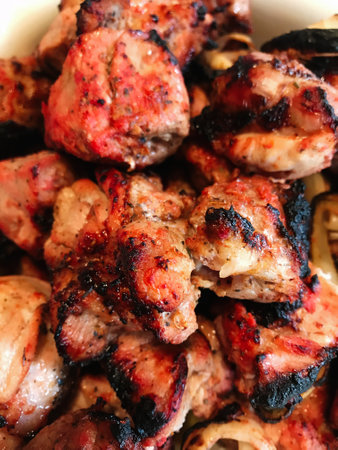 Close-up of deliciously grilled meat skewers with a smoky, charred exterior. Perfectly seasoned,...