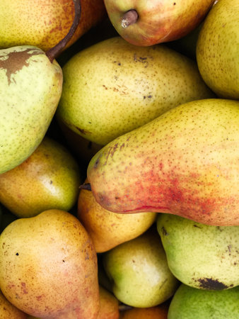 A vibrant close-up of ripe pears displaying their natural colors and textures. Perfect for...